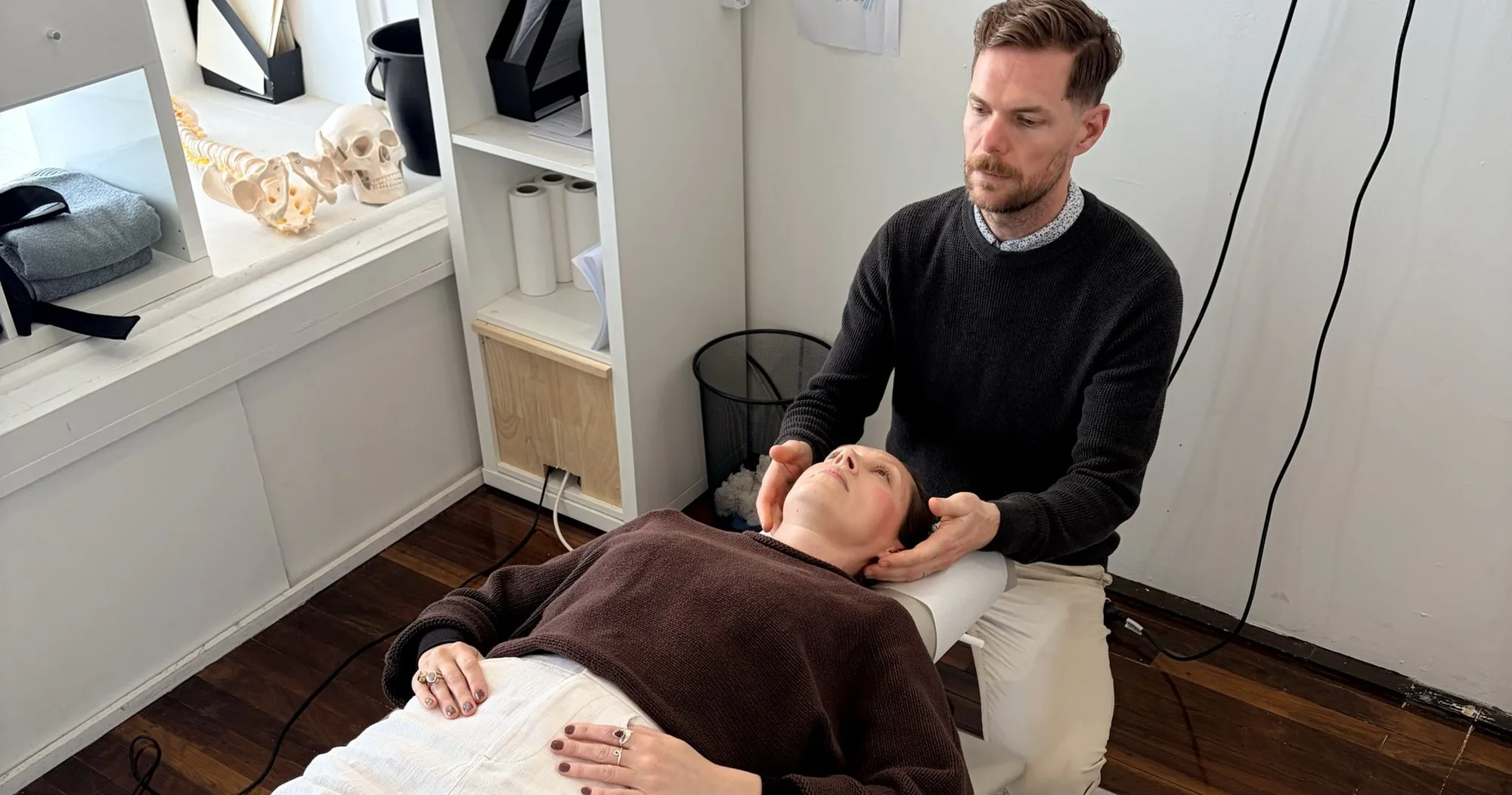 A chiropractor assessing a patient